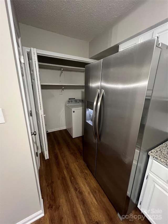 kitchen featuring stainless steel fridge, dark hardwood / wood-style flooring, light stone counters, a textured ceiling, and white cabinets