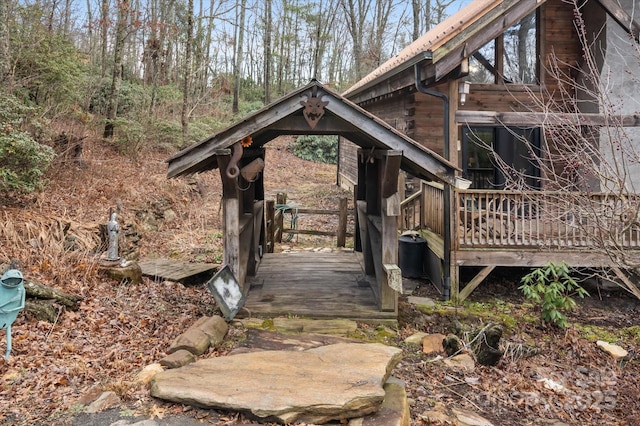 view of side of property featuring a wooden deck