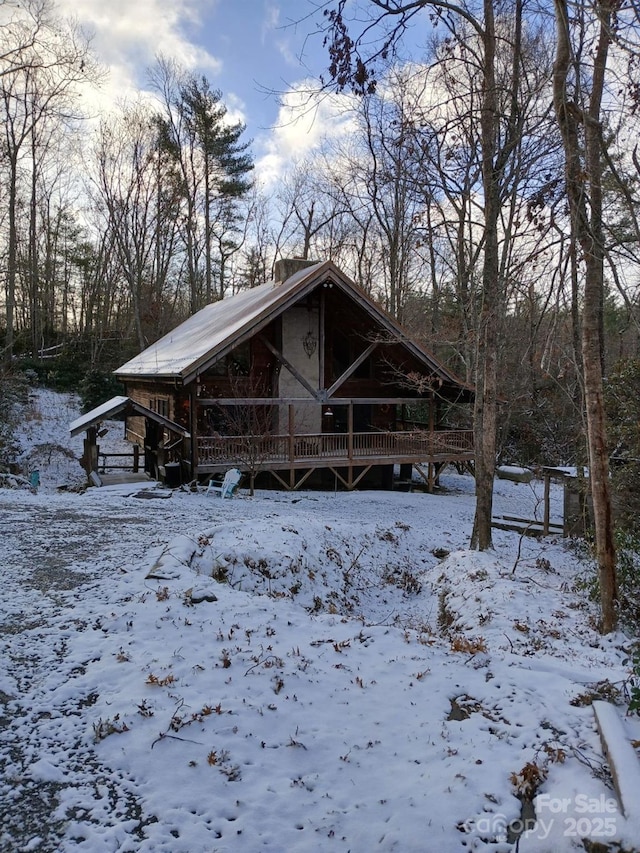 view of snow covered back of property