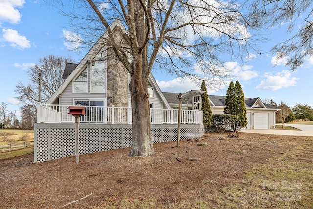 view of home's exterior featuring a wooden deck and a garage