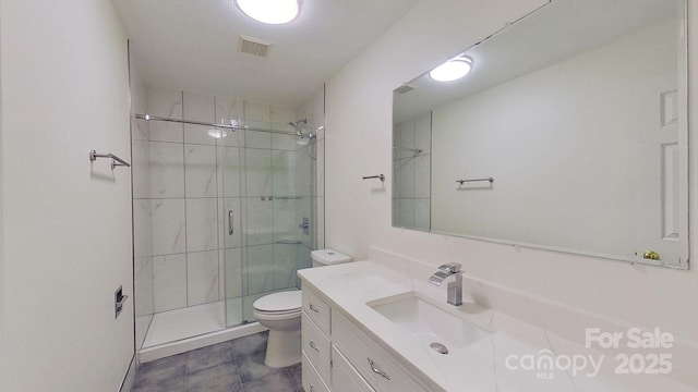 bathroom with tile patterned floors, vanity, toilet, and walk in shower