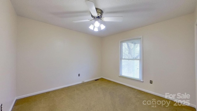 unfurnished room with carpet flooring, a textured ceiling, and ceiling fan