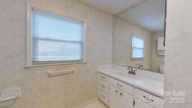 bathroom featuring vanity and toilet