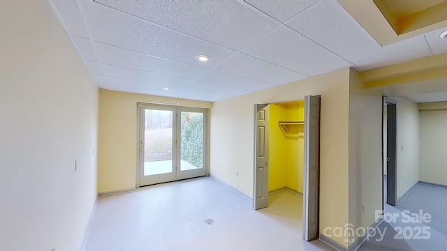 interior space with a walk in closet, french doors, and a closet