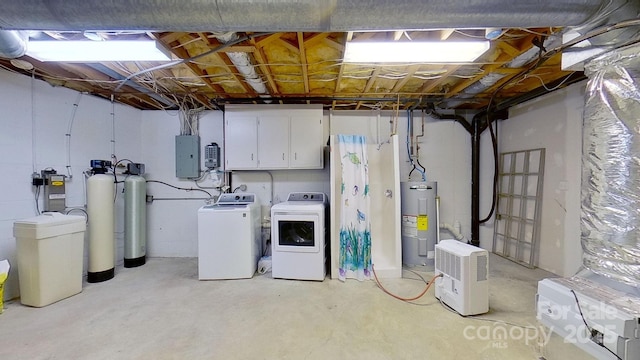 basement featuring washing machine and dryer, electric panel, and water heater