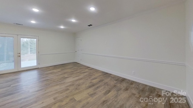 unfurnished room with crown molding, french doors, and hardwood / wood-style floors