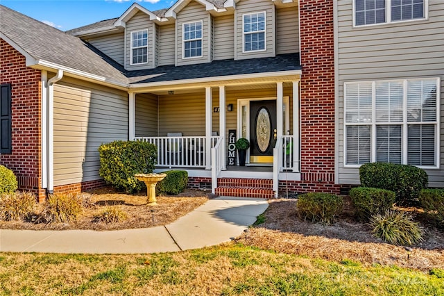 view of exterior entry with covered porch