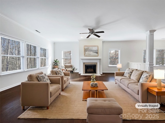 living room featuring hardwood / wood-style floors, decorative columns, ceiling fan, and ornamental molding