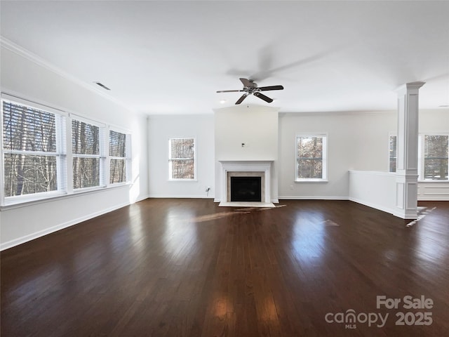 unfurnished living room featuring ornate columns, plenty of natural light, crown molding, and ceiling fan