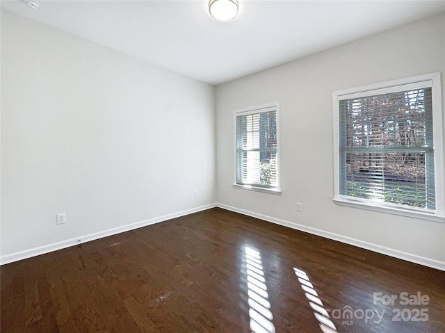 empty room with dark hardwood / wood-style floors