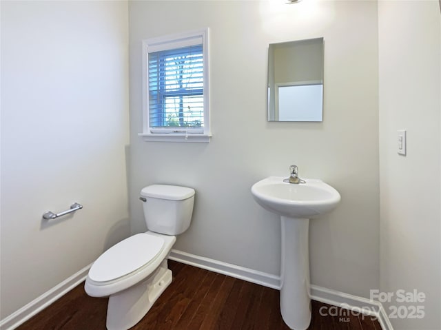 bathroom with hardwood / wood-style floors and toilet