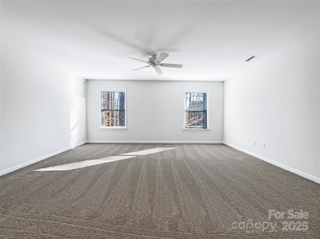 carpeted spare room with ceiling fan