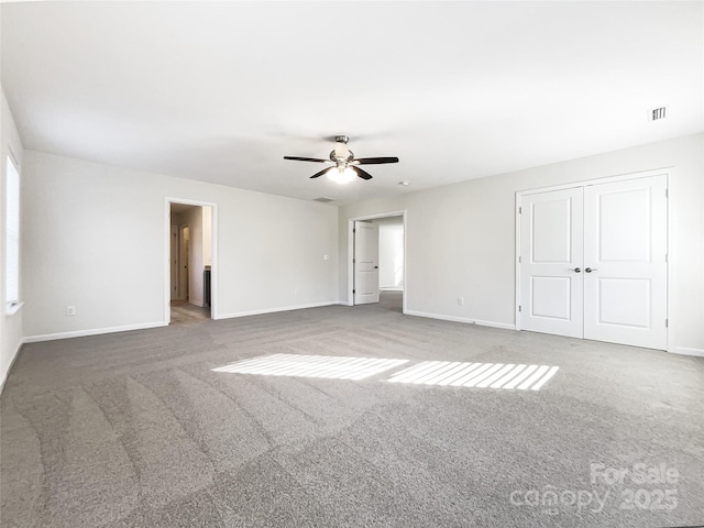 spare room with ceiling fan and carpet floors