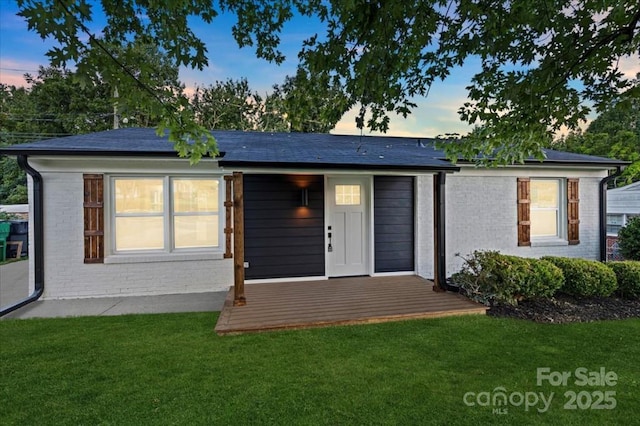 view of front of home with a lawn