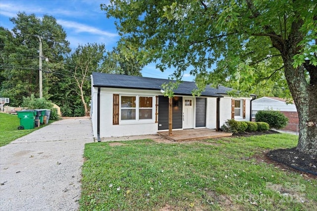 ranch-style house with a front yard and a porch