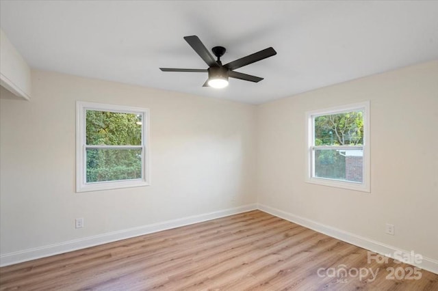 spare room with ceiling fan and light hardwood / wood-style flooring