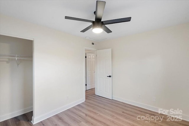 unfurnished bedroom featuring light wood-type flooring, a closet, and ceiling fan