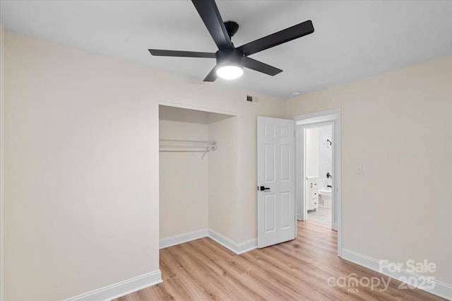 unfurnished bedroom featuring ceiling fan, light hardwood / wood-style flooring, and a closet