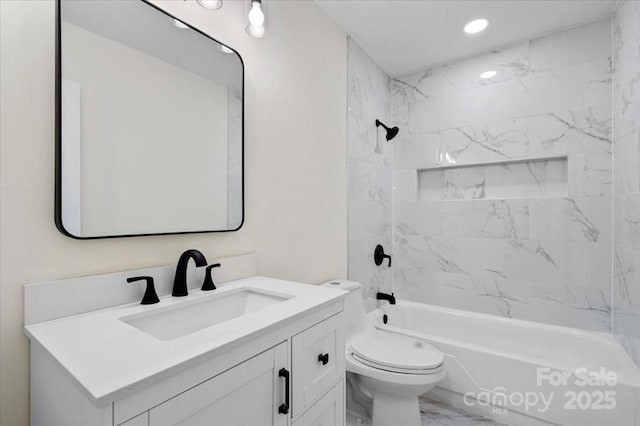 full bathroom featuring vanity, tiled shower / bath combo, and toilet