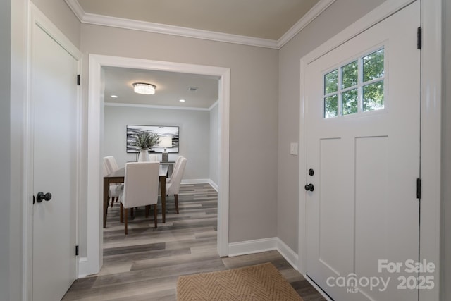 foyer entrance featuring wood-type flooring and ornamental molding