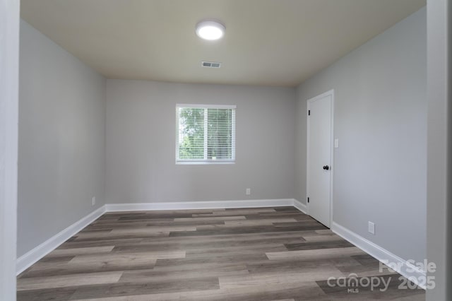 spare room featuring hardwood / wood-style flooring