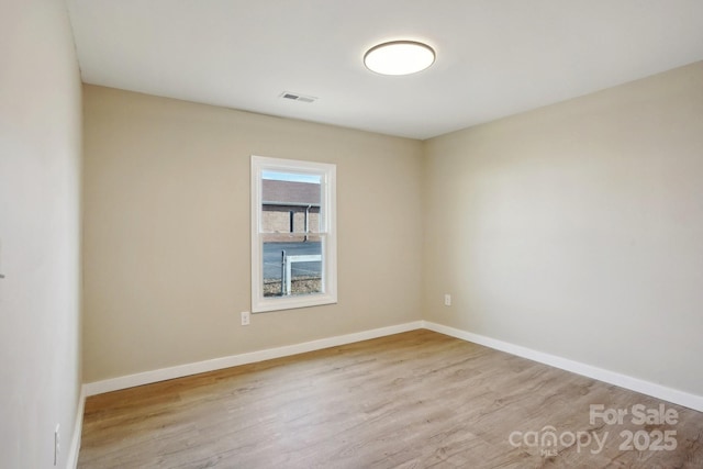 empty room with light hardwood / wood-style flooring