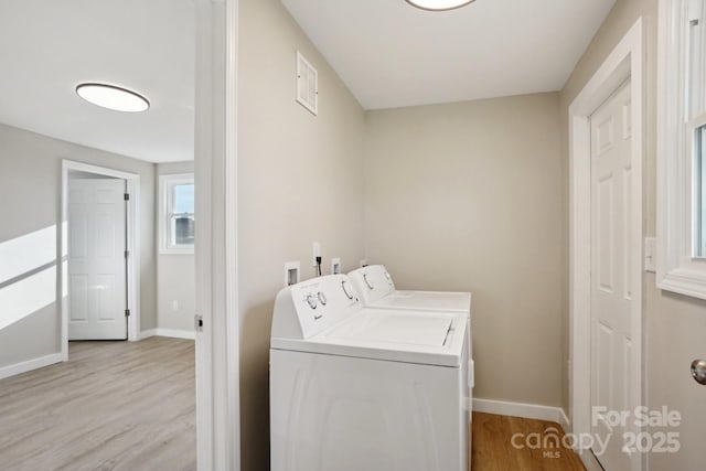 laundry room featuring light wood-type flooring and washing machine and dryer