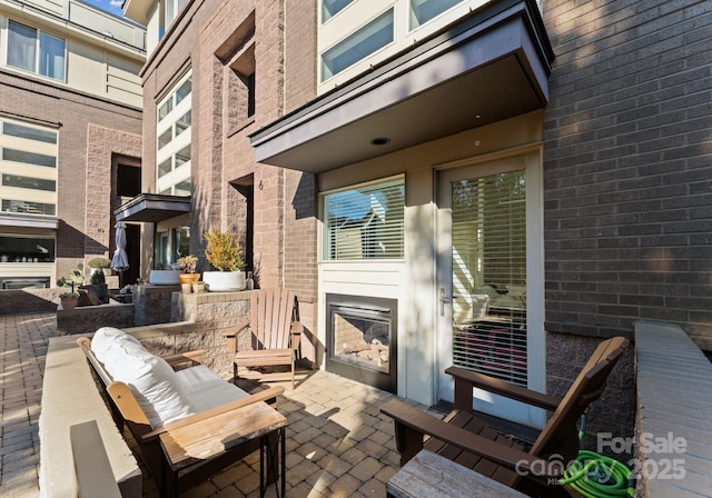 view of patio / terrace featuring exterior fireplace