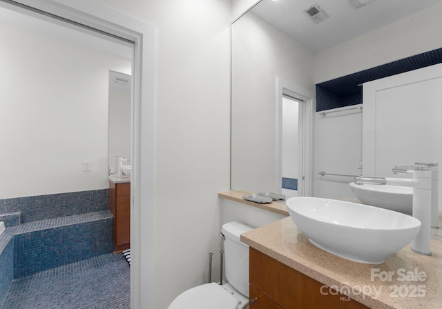 bathroom with tile patterned floors, vanity, and toilet