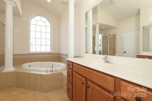 bathroom featuring tile patterned flooring, vanity, separate shower and tub, and vaulted ceiling