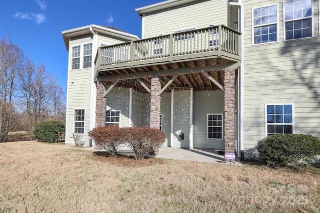 rear view of property with a patio area and a yard