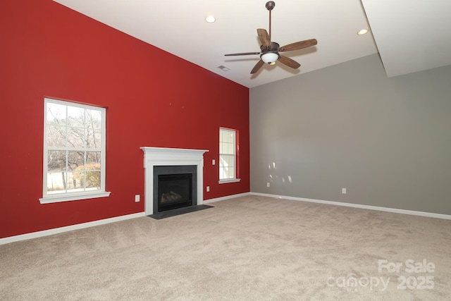 unfurnished living room featuring light colored carpet, ceiling fan, and lofted ceiling