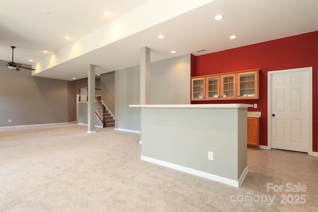 interior space with ceiling fan and light carpet