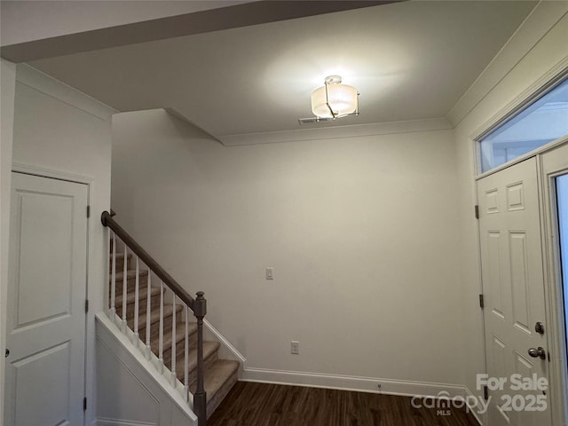 stairs with crown molding and hardwood / wood-style floors