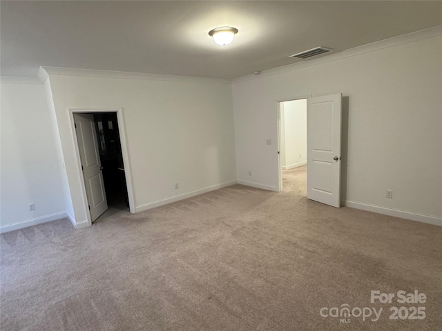 carpeted spare room featuring ornamental molding