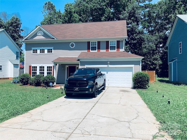 view of front facade with a front lawn, fence, and driveway