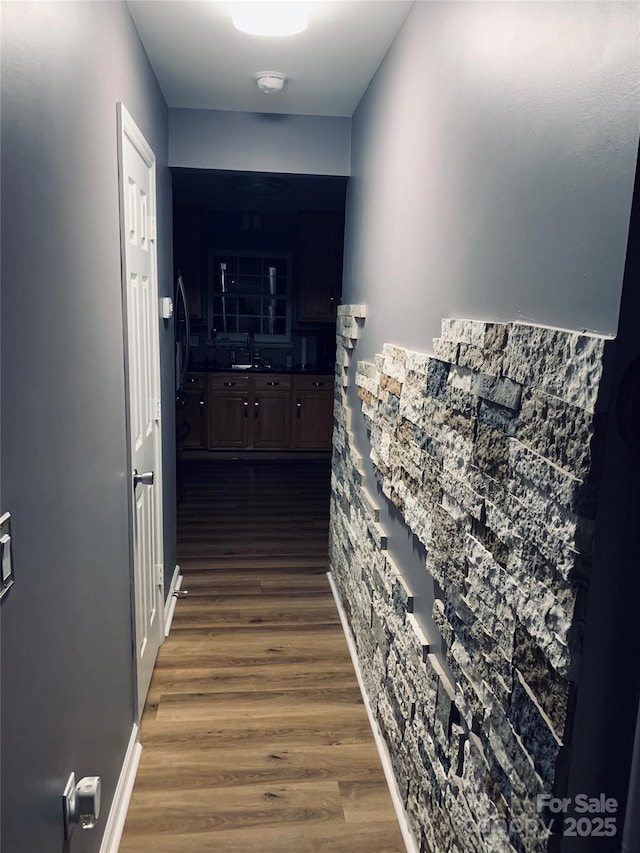 hall featuring a sink and dark wood finished floors