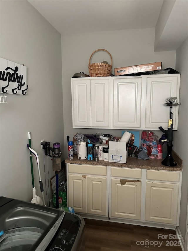 interior space featuring dark wood-type flooring and washer / clothes dryer