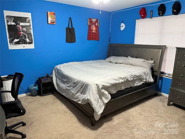 carpeted bedroom featuring baseboards