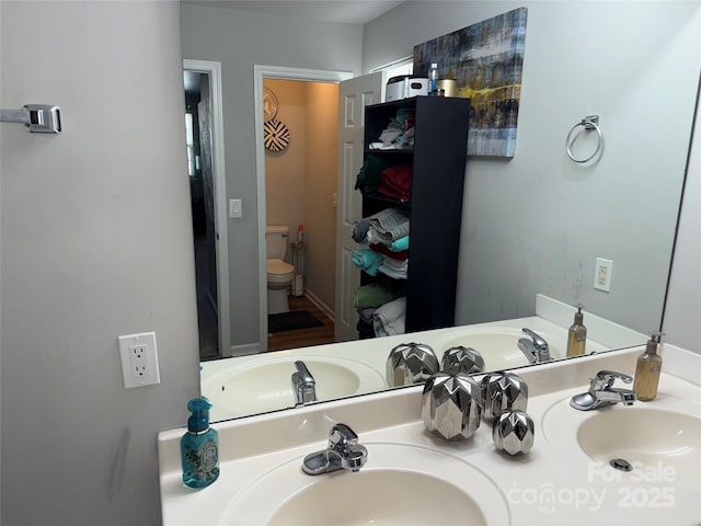 9624 Langston Mill Rd, Charlotte, NC 28216 - bathroom featuring a sink, toilet, and double vanity