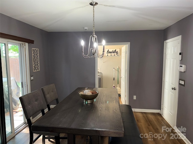 9624 Langston Mill Rd, Charlotte, NC 28216 - dining space with baseboards, dark wood-style flooring, and a chandelier