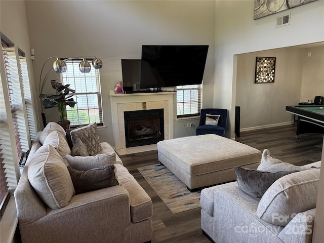 9624 Langston Mill Rd, Charlotte, NC 28216 - living room with visible vents, a towering ceiling, wood finished floors, and a healthy amount of sunlight