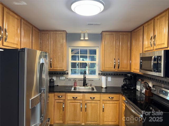 9624 Langston Mill Rd, Charlotte, NC 28216 - kitchen with a sink, appliances with stainless steel finishes, tasteful backsplash, and brown cabinetry