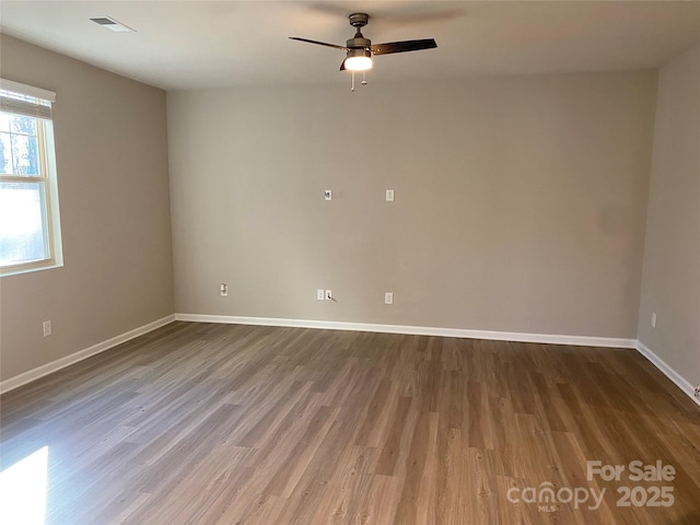 empty room with hardwood / wood-style flooring and ceiling fan