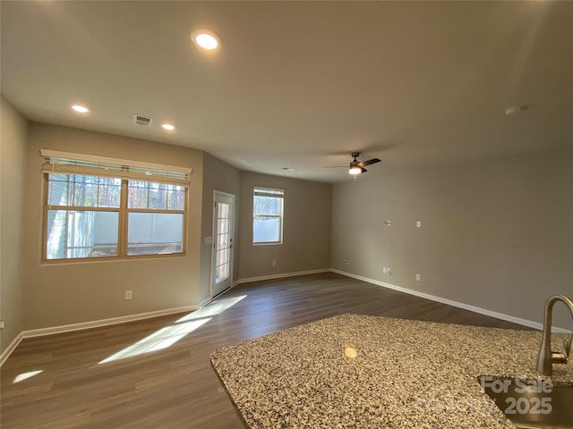 unfurnished room featuring dark hardwood / wood-style flooring and ceiling fan