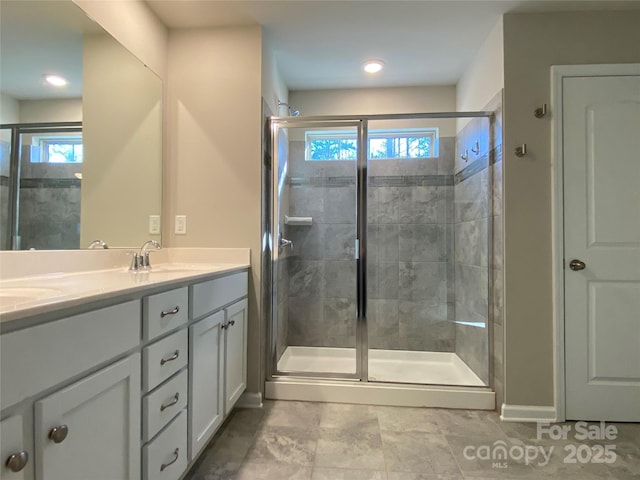 bathroom featuring vanity and a shower with shower door