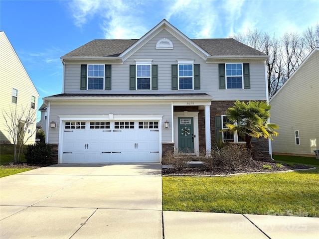 view of front of home featuring a front lawn and a garage