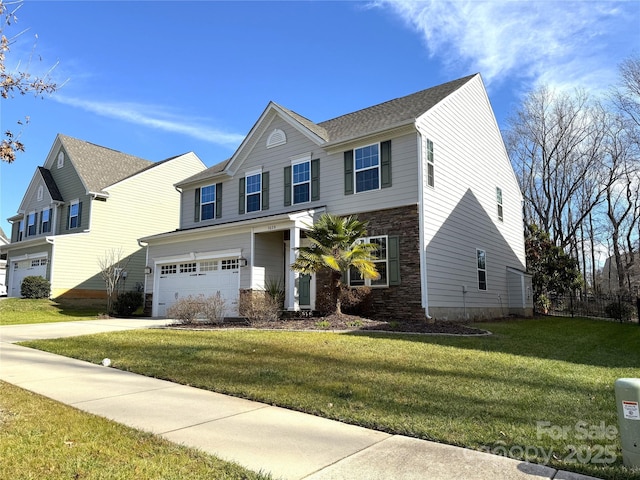 view of front of property featuring a front yard and a garage