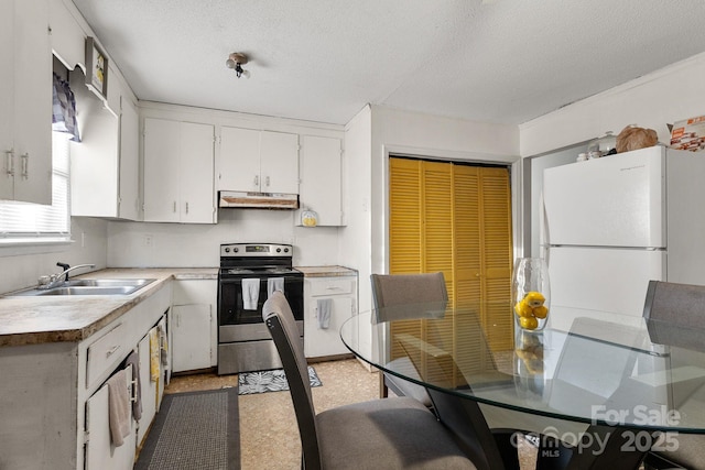 kitchen featuring white cabinets, white fridge, stainless steel electric stove, and sink