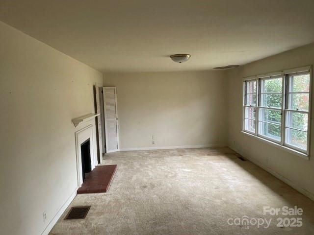 unfurnished living room featuring carpet